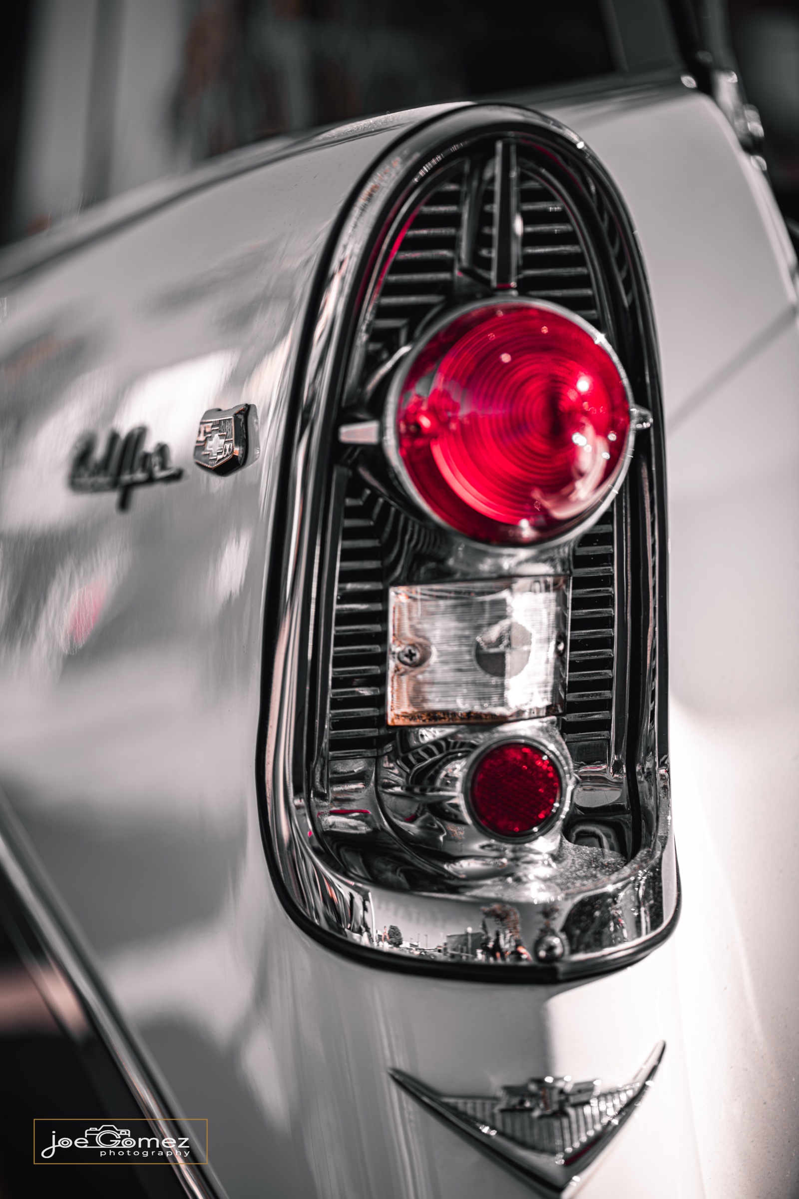 Sculpted red taillight against monochrome chrome and white bodywork