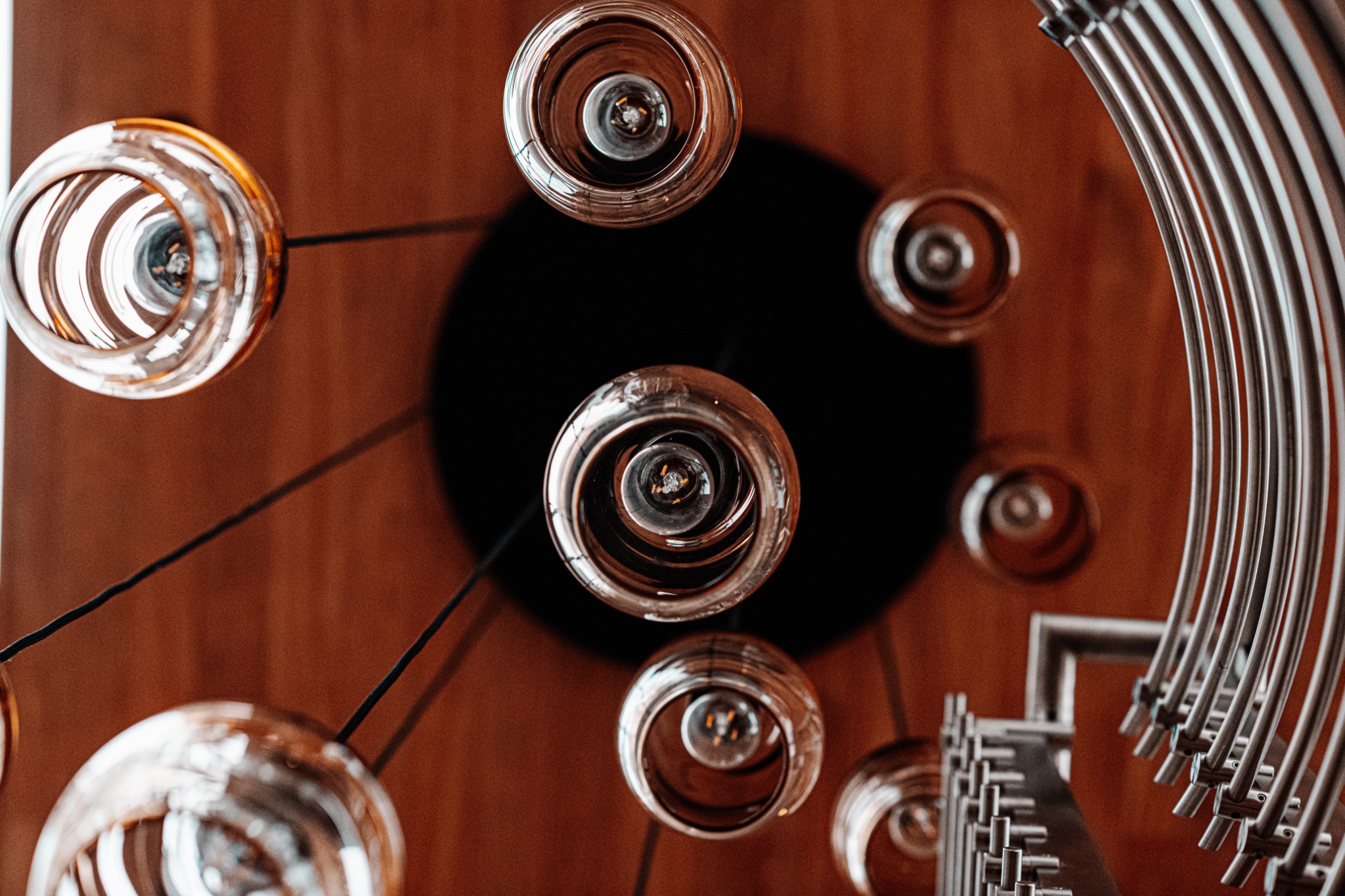 Circular glass pendant lights and curved architectural lines viewed from below