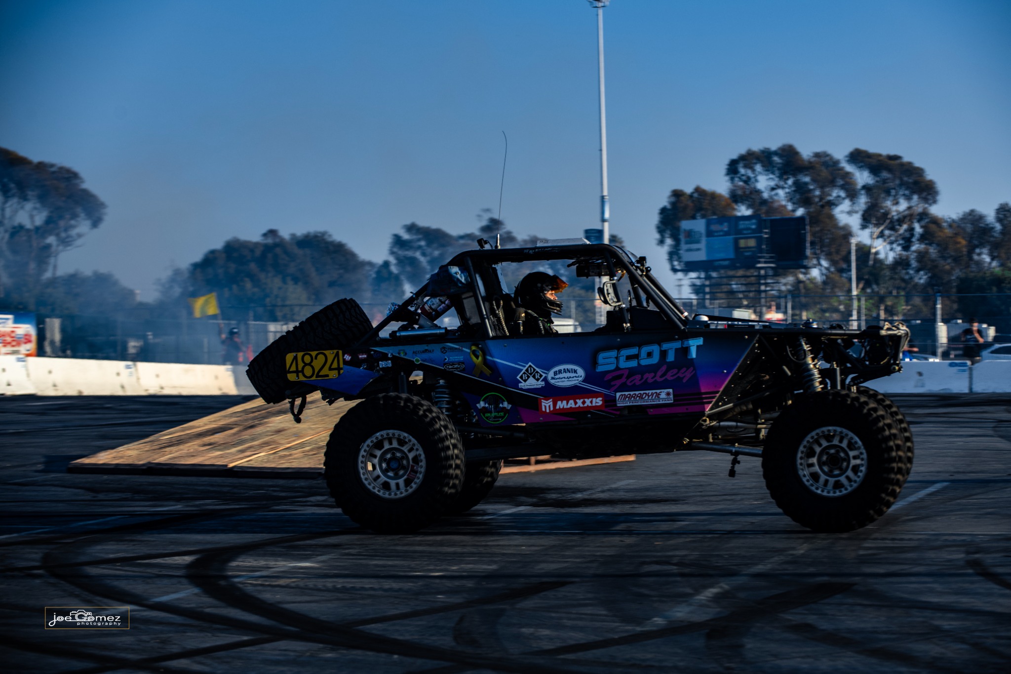 An off-road buggy bearing number 4824 crossing the arena