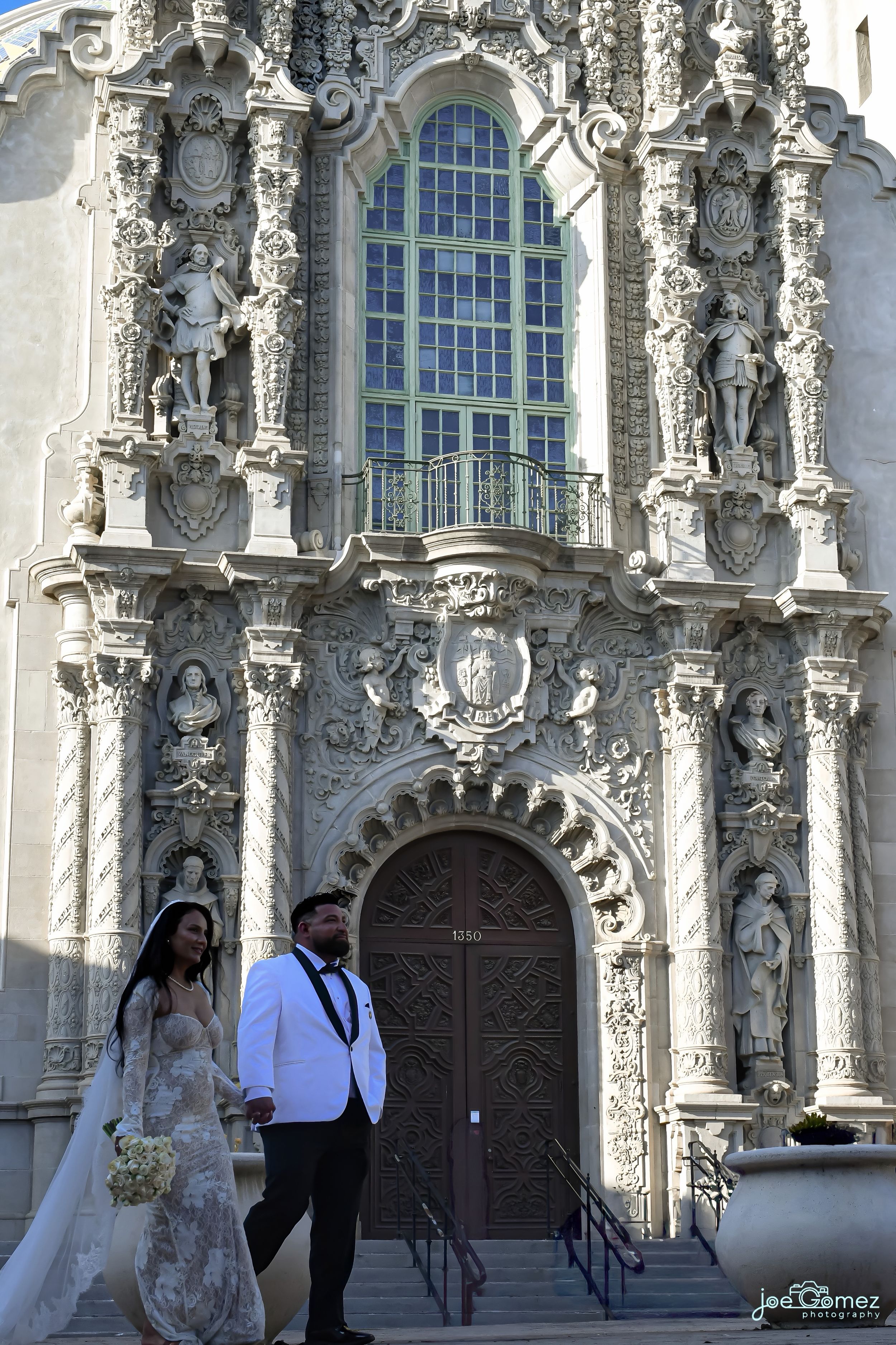 Editorial wedding portrait outside the ornate Casa del Prado entrance in Balboa Park, San Diego.