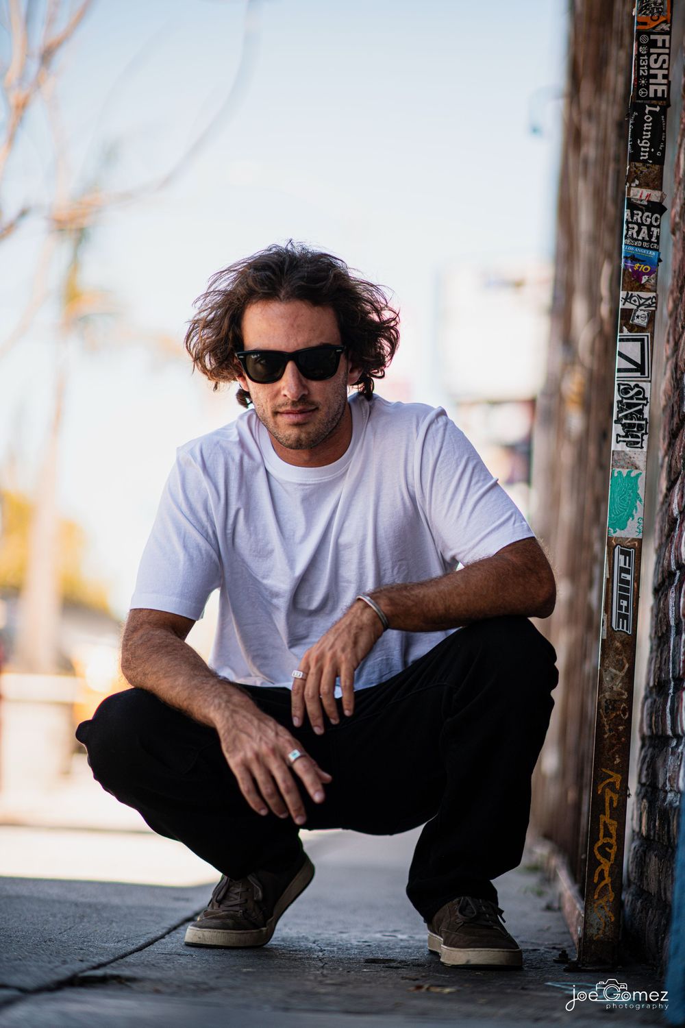 Outdoor editorial fashion portrait of a male model wearing sunglasses in Southern California, photographed by Joe Gomez.
