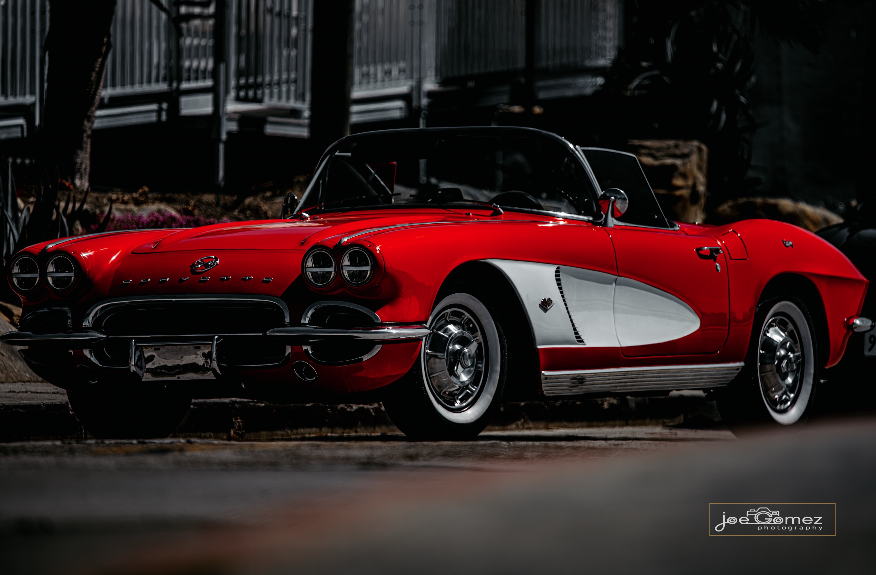 Fine-art automotive photograph of a red-and-white classic Chevrolet Corvette displayed at an Orange County car show in Southern California, photographed by Joe Gomez.